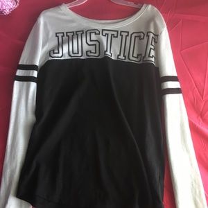 A black and white long sleeve with a Justice logo.